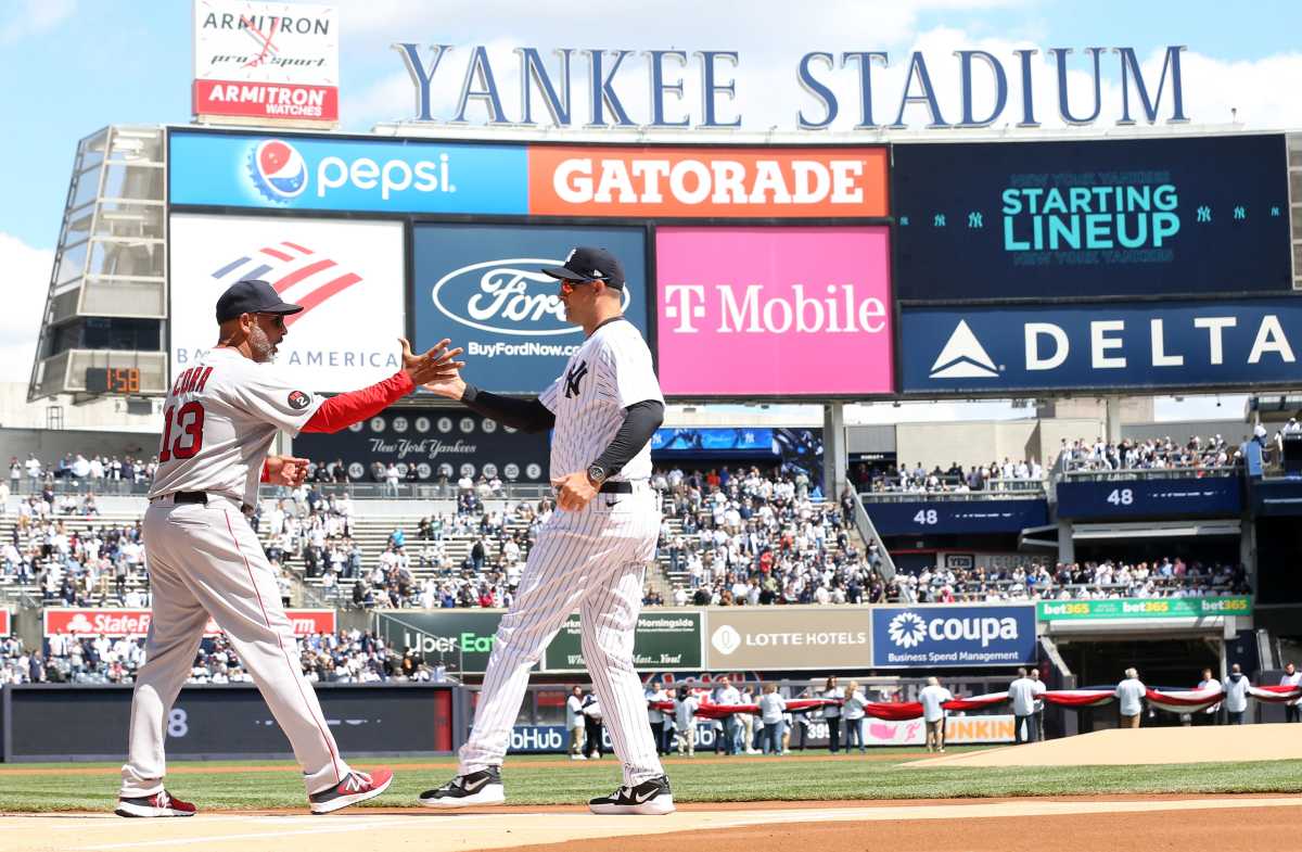 Red Sox manager Alex Cora and Yankee manager Aaron Boone shake hands prior to start of opening day game at Yankee Stadium April 8, 2022.