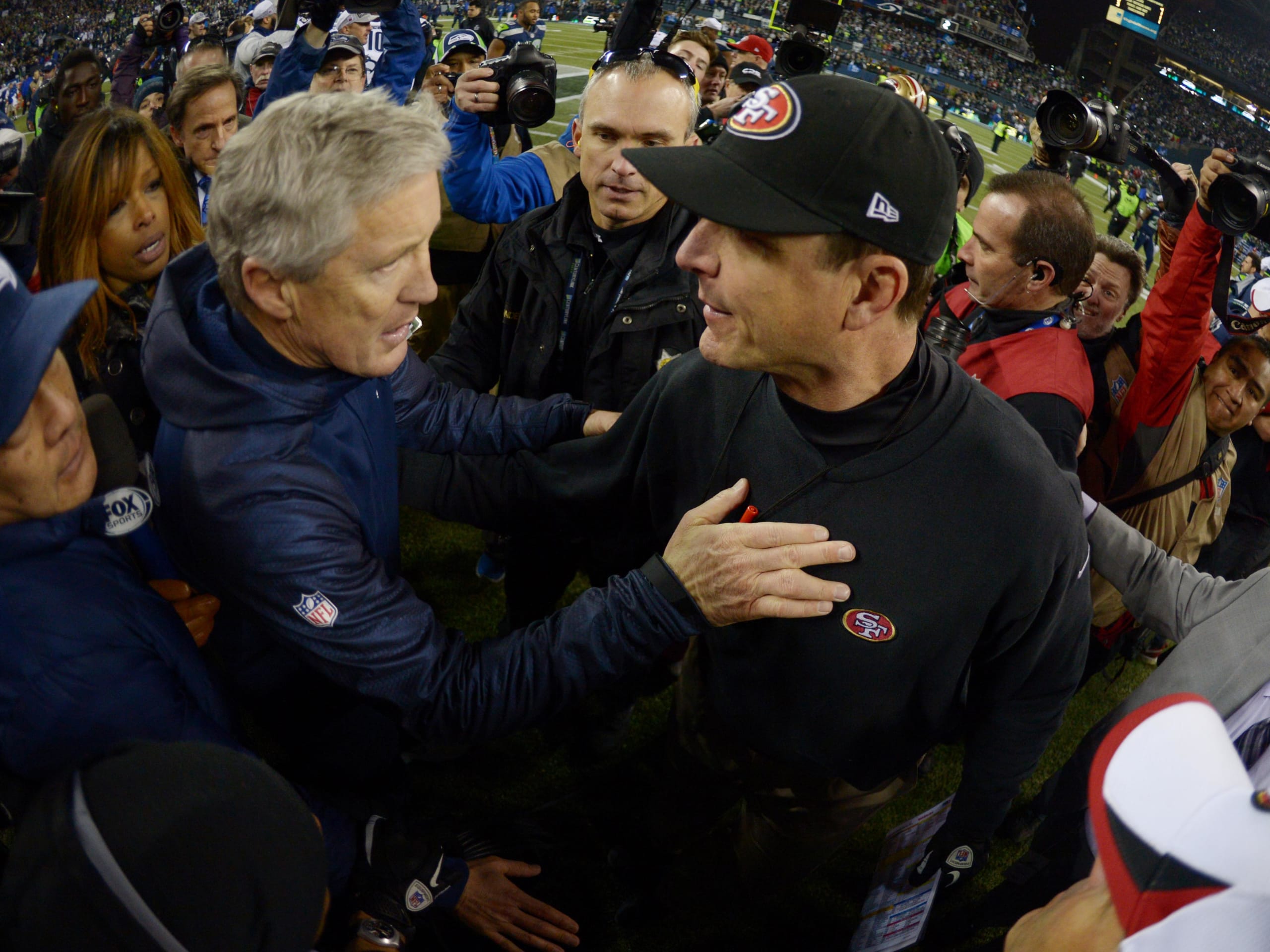 Jan 19, 2014; Seattle, WA, USA; Seattle Seahawks head coach Pete Carroll (left) shakes hands with San Francisco 49ers head coach Jim Harbaugh (right) after the 2013 NFC Championship football game at CenturyLink Field. Mandatory Credit: Kirby Lee-Imagn Images