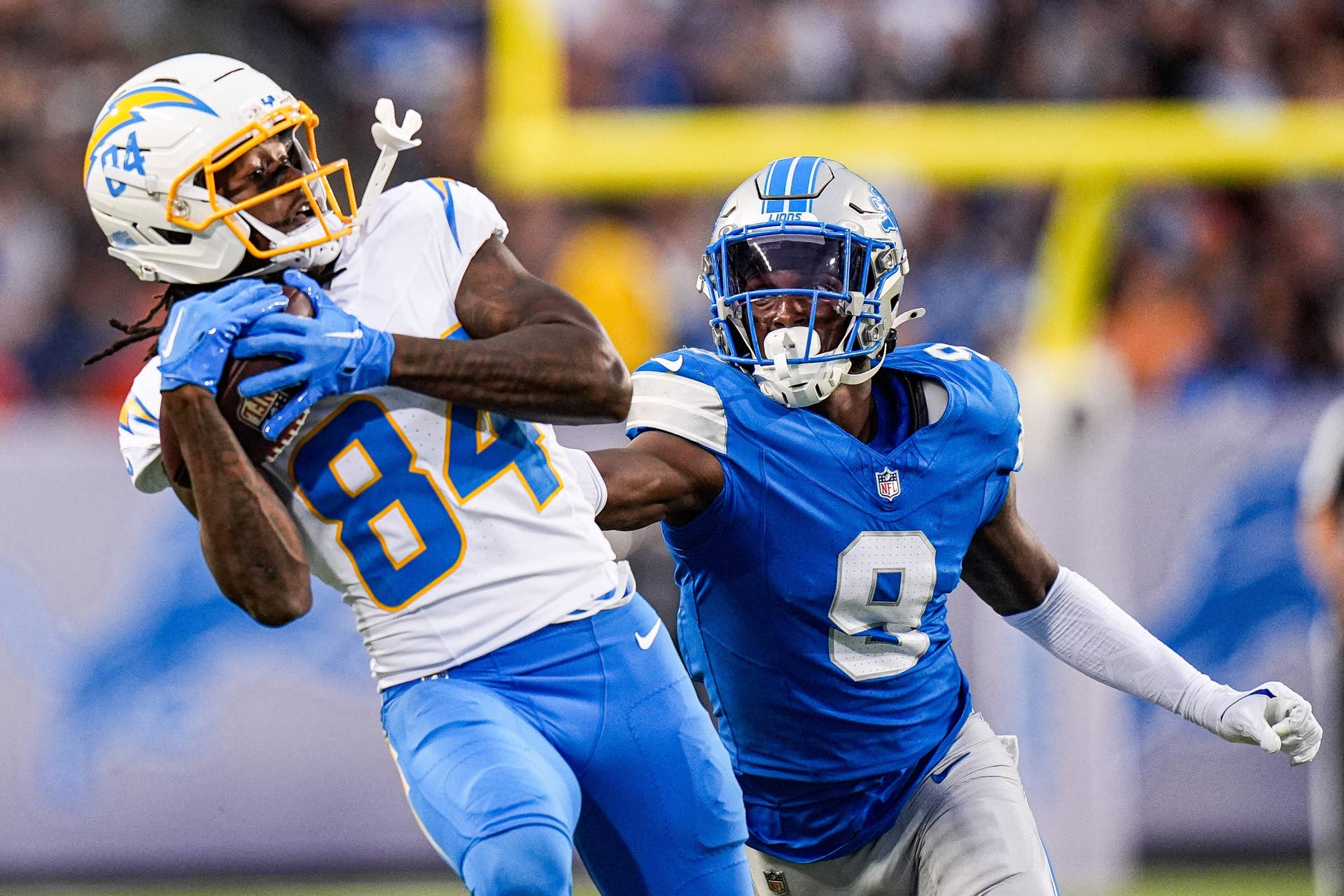 LA Chargers wide receiver KeAndre Lambert-Smith (84) makes a catch against Detroit Lions cornerback Ennis Rakestraw Jr. (9) during the first half of the Hall of Fame Game at Tom Benson Hall of Fame Stadium in Canton, Ohio on Thursday, July 31, 2025.
