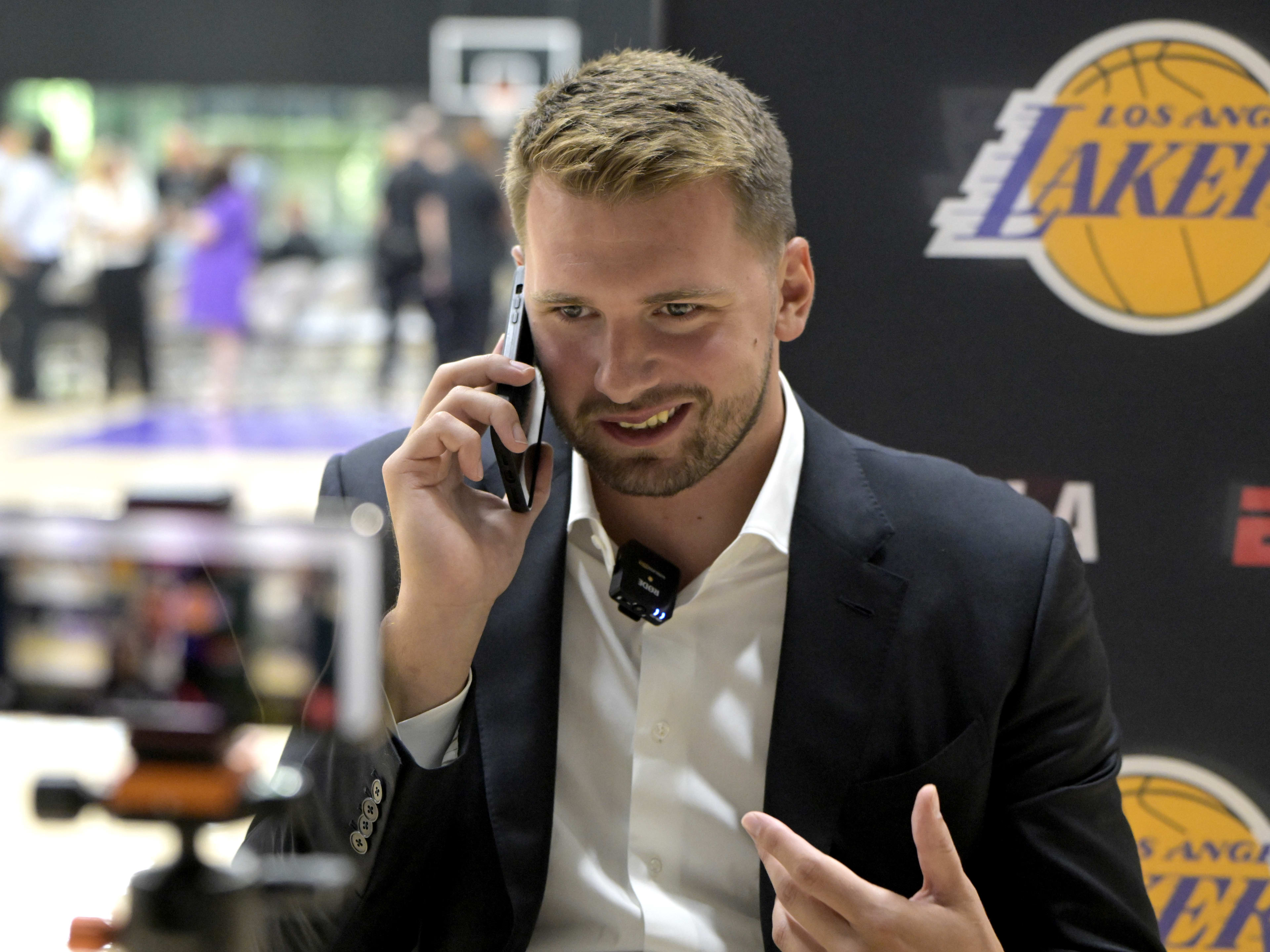 Aug 2, 2025; El Segundo, CA, USA; Los Angeles Lakers Luka Doncic (77) is interviewed by ESPN LA radio following a press conference announcing the signing of a 3-year, $165 million contract extension at UCLA Health Training Center. Mandatory Credit: Jayne Kamin-Oncea-Imagn Images
