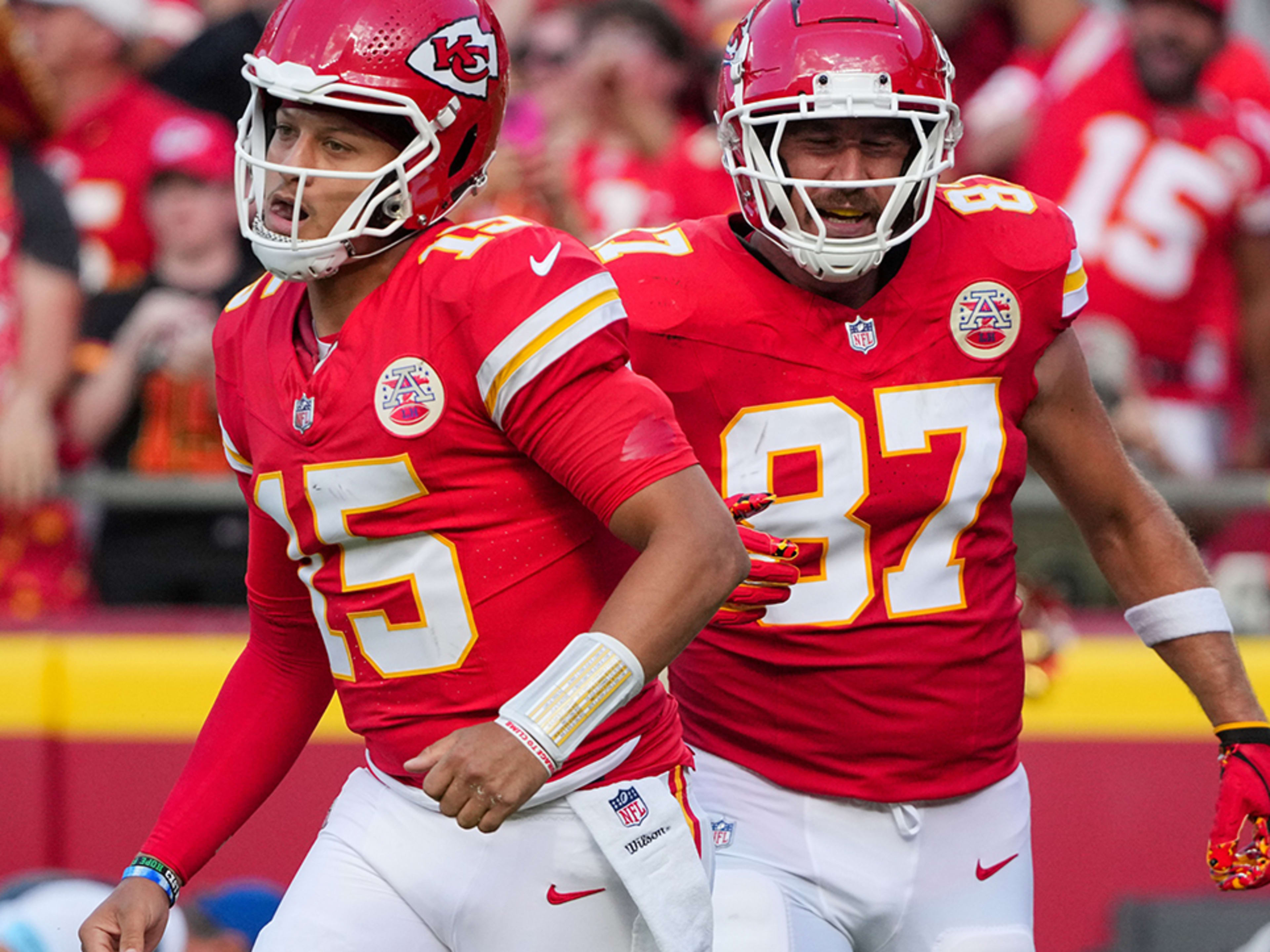 Kansas City Chiefs quarterback Patrick Mahomes and tight end Travis Kelce return to the sideline after a score against the Cincinnati Bengals at Arrowhead Stadium on Sept. 15, 2024.