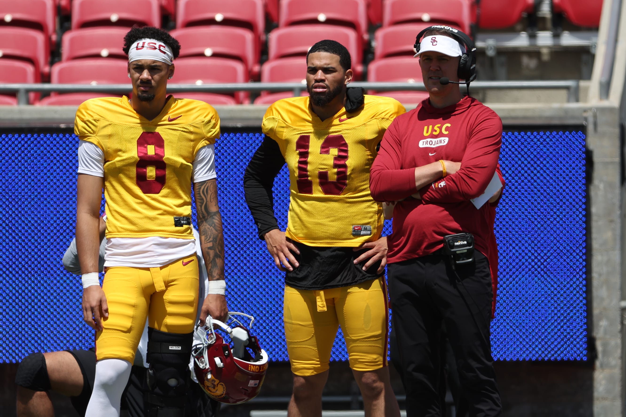 USC Trojans quarterback Malachi Nelson (8) and Caleb Williams (13) and head coach Lincoln Riley watch the game from the sideline during the Spring Game.