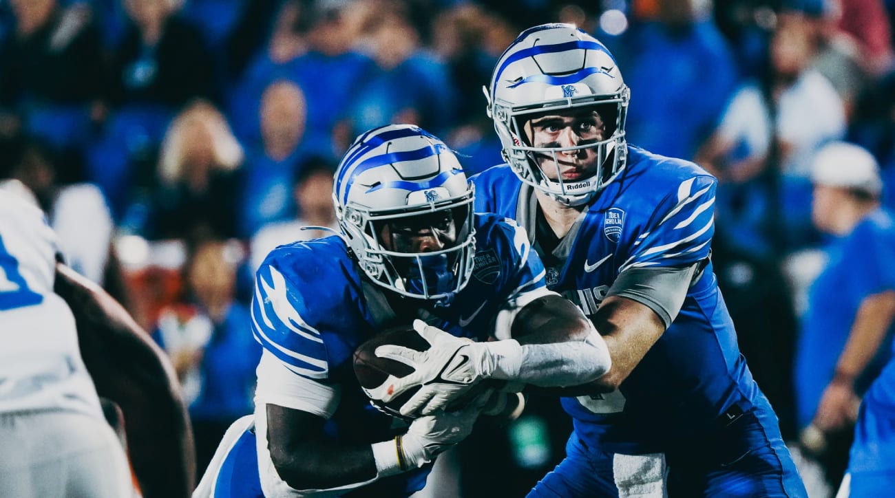 Memphis Tigers’ Seth Henigan (9) hands off the ball to teammate Mario Anderson (2) as he rushes against MTSU during a football game on Saturday, Sept. 28, 2024 at the Simmons Liberty Bank Stadium in Memphis, Tenn.