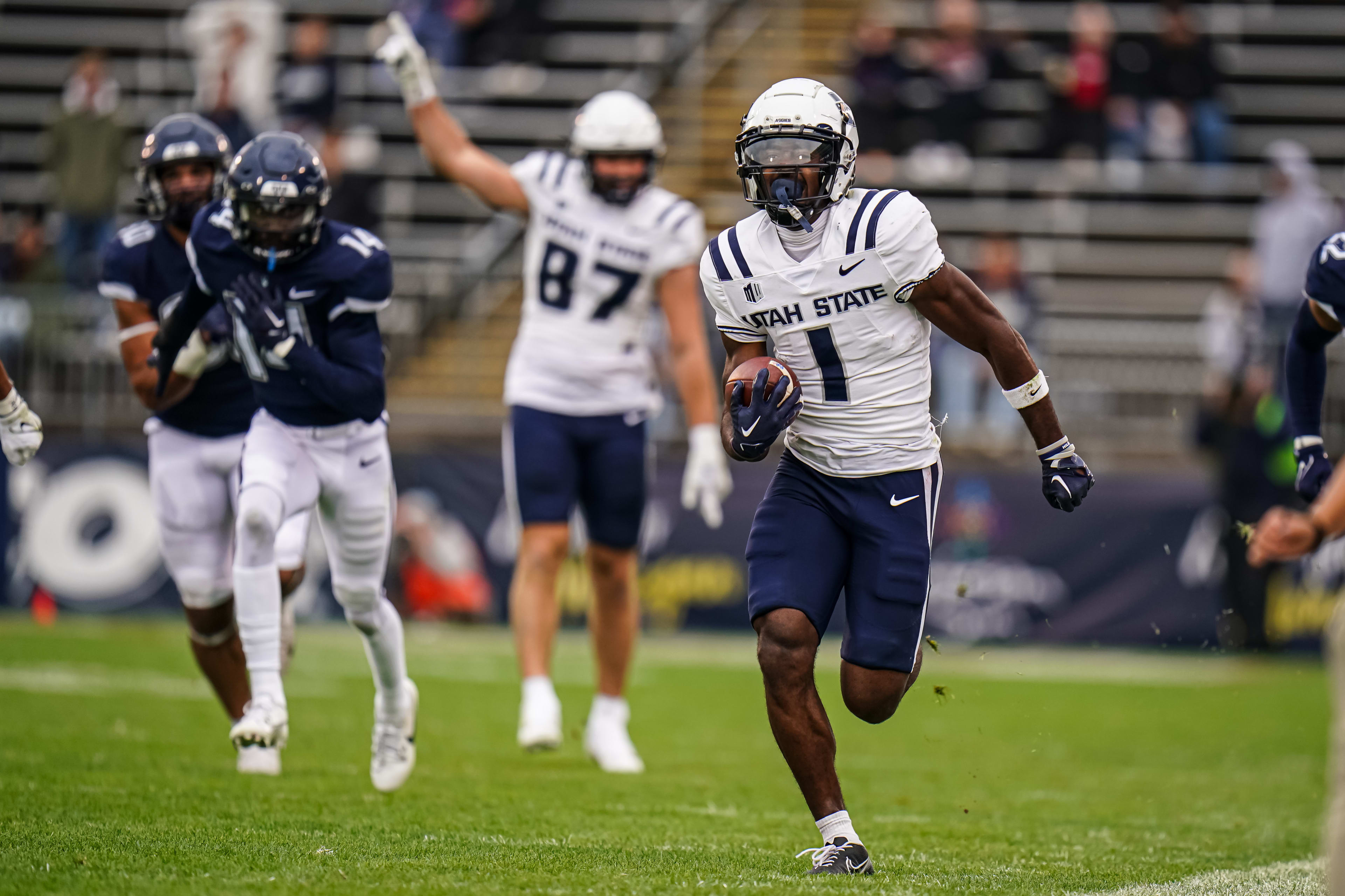Sep 30, 2023; East Hartford, Connecticut, USA; Utah State Aggies wide receiver Jalen Royals (1) runs the ball for a touchdown against the UConn Huskies in the second half at Rentschler Field at Pratt & Whitney Stadium. Mandatory Credit: David Butler II-Imagn Images