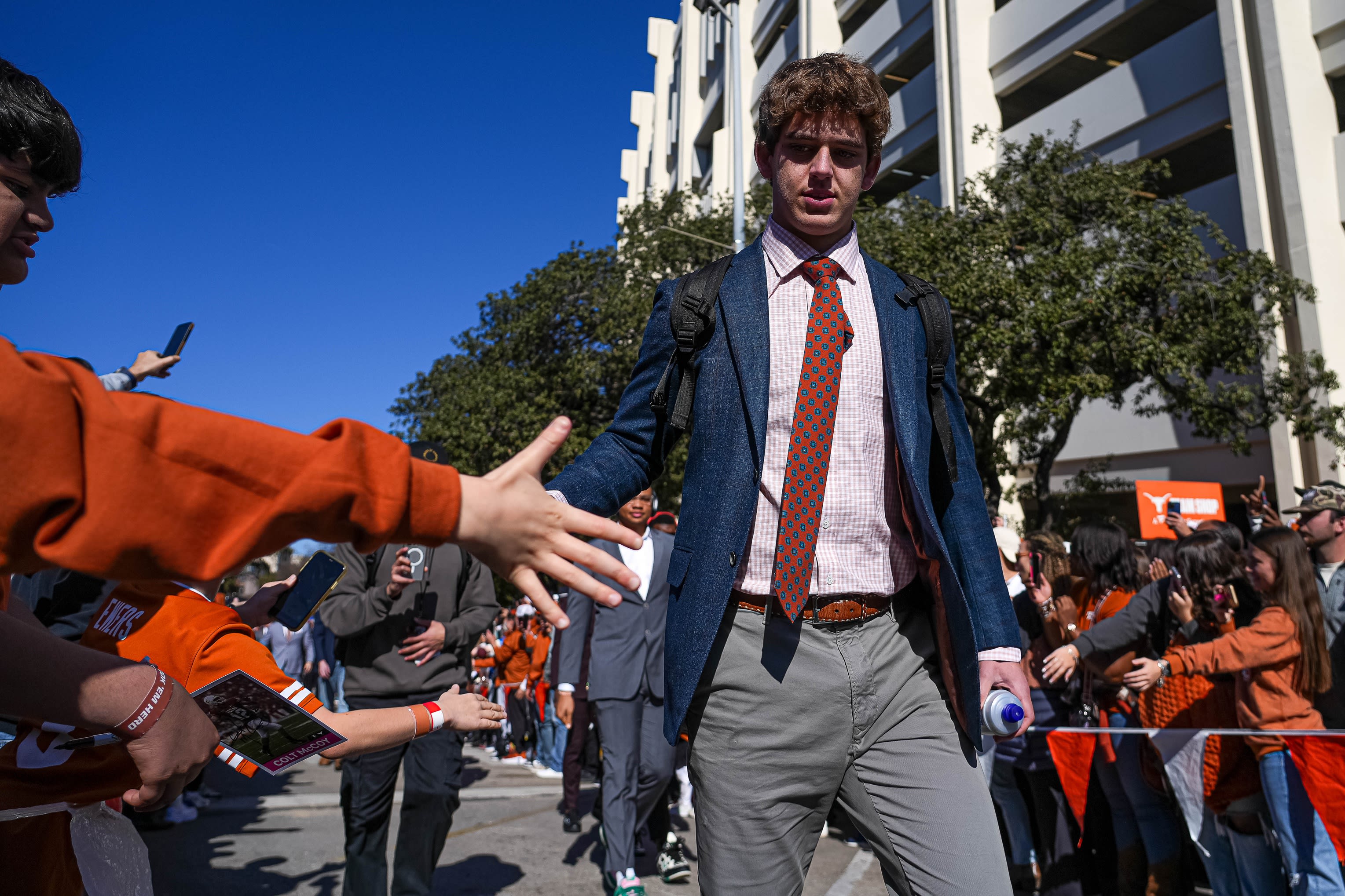 Texas Longhorns quarterback Arch Manning is greeted by fans before his team's College Football Playoff game against the Clemson Tigers outside Darrell K Royal-Texas Memorial Stadium on Dec. 21, 2024.