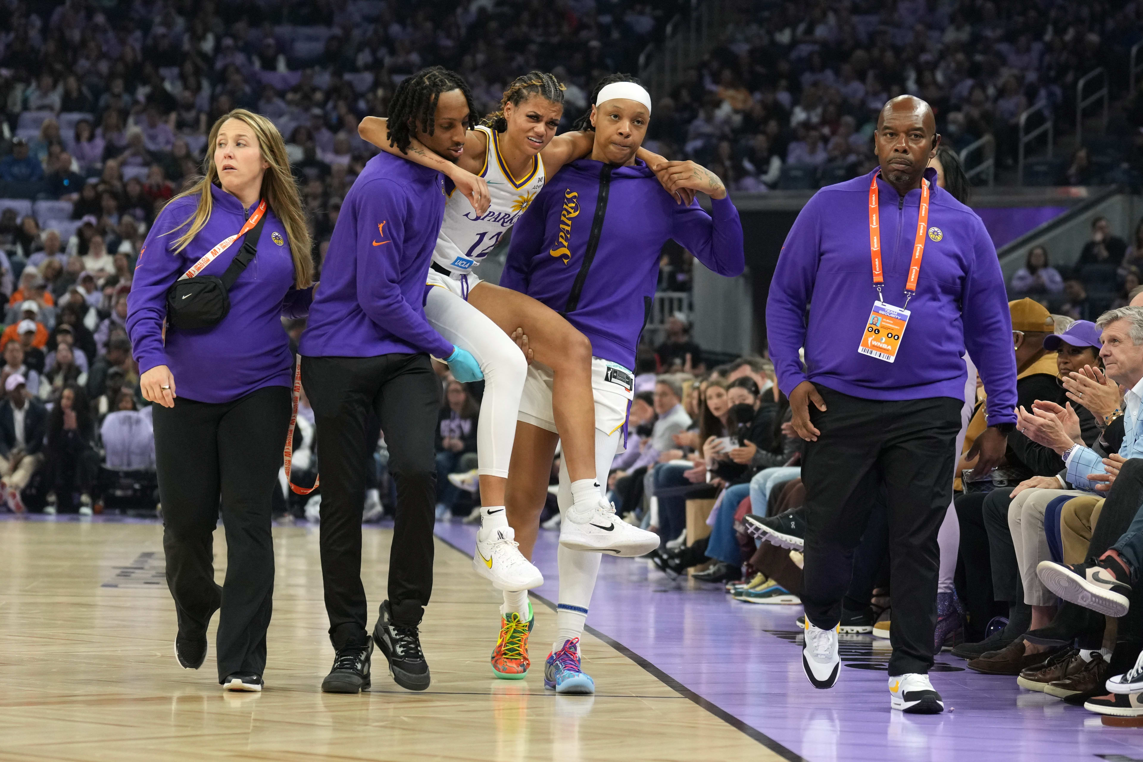 Los Angeles Sparks guard Rae Burrell (12) is carried off of the court after suffering an injury during the first quarter against the Golden State Valkyries at Chase Center.