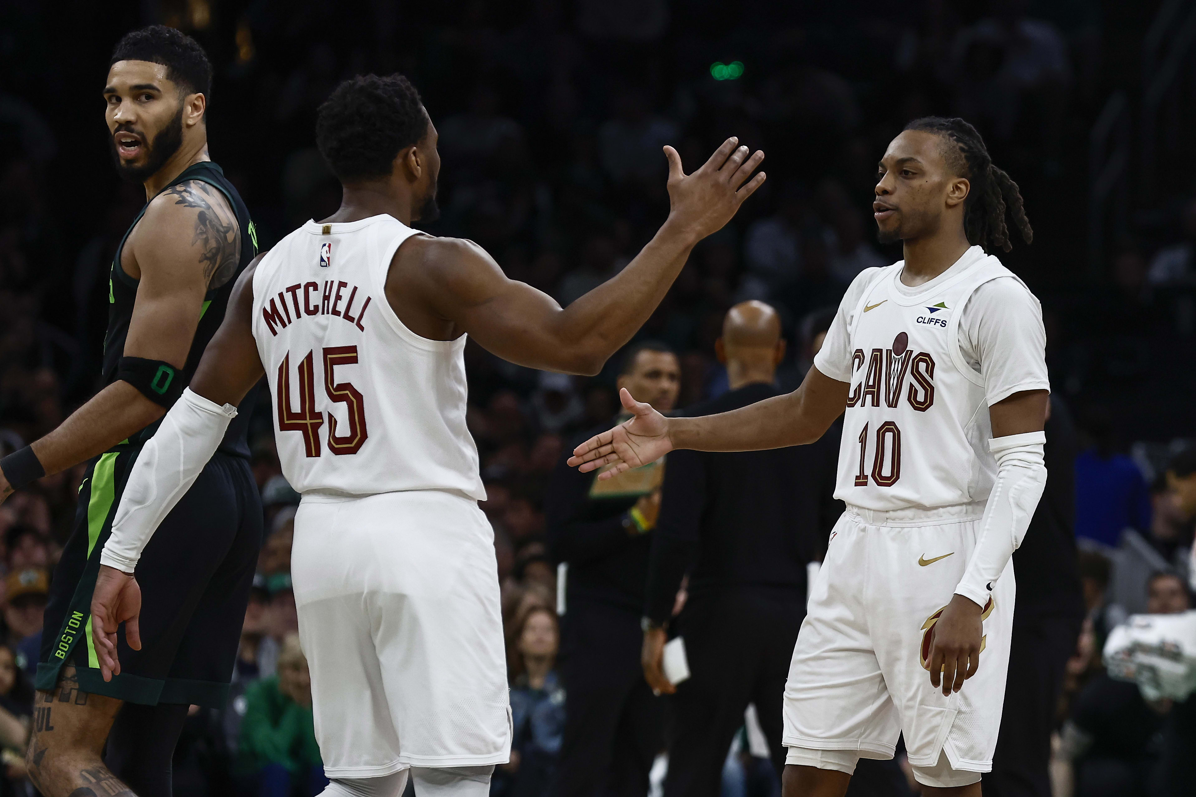 Cleveland Cavaliers guard Donovan Mitchell (45) and guard Darius Garland (10) congratulate each other as Boston Celtics forward Jayson Tatum (0) looks back during the second half at TD Garden.