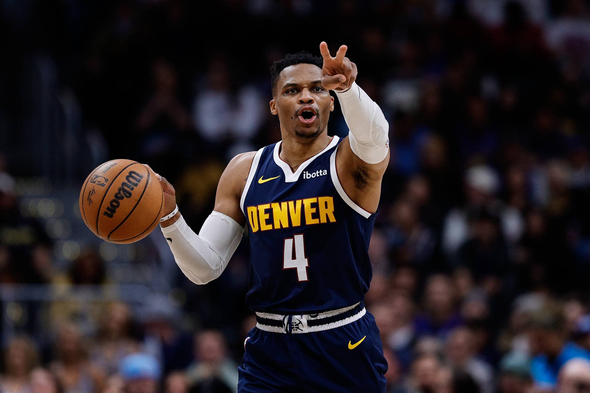 Denver Nuggets guard Russell Westbrook (4) gestures as he dribbles the ball up court in the third quarter against the San Antonio Spurs at Ball Arena.