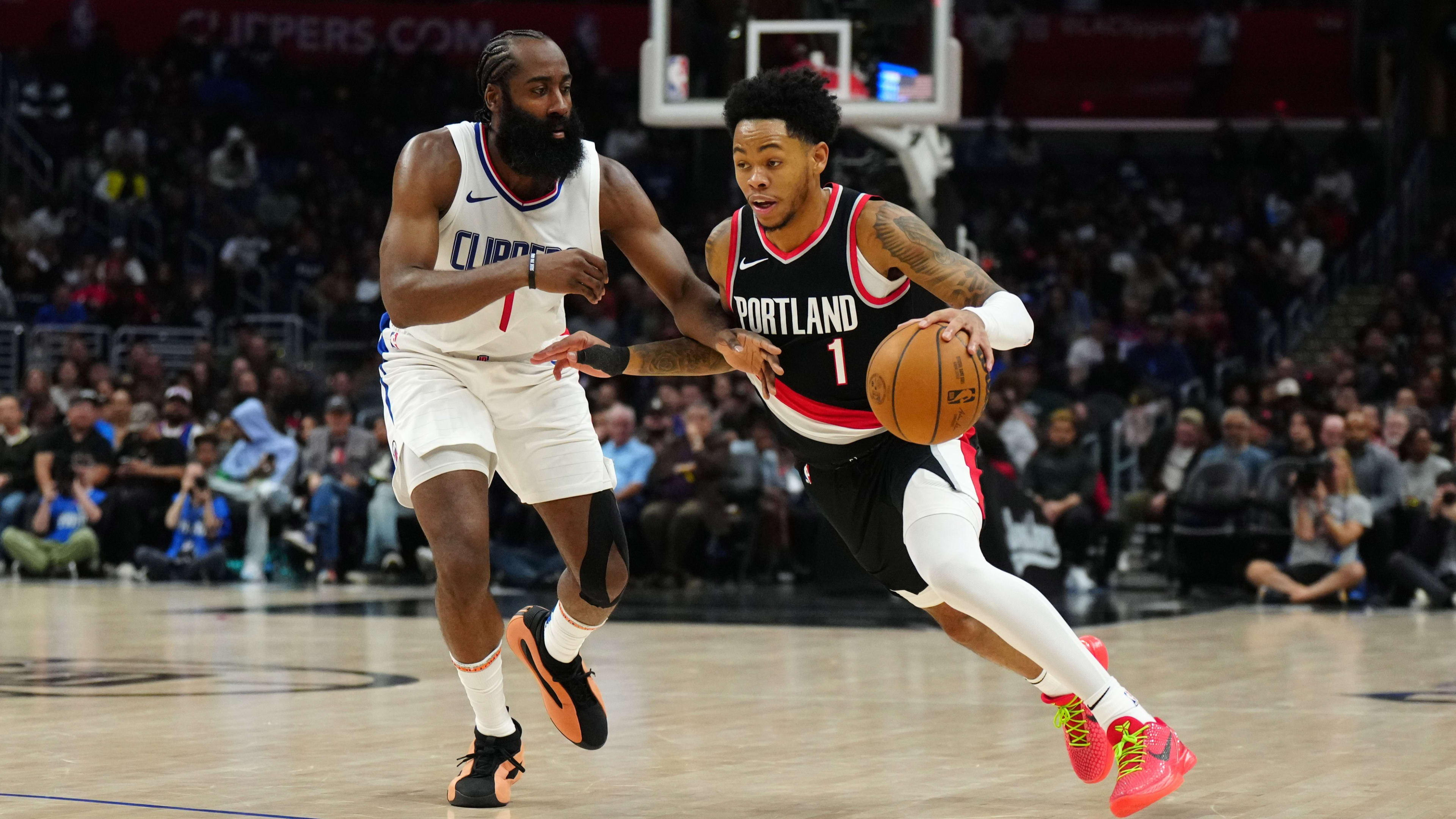 Los Angeles Clippers guard James Harden (1) and Portland Trail Blazers guard Anfernee Simons (1)