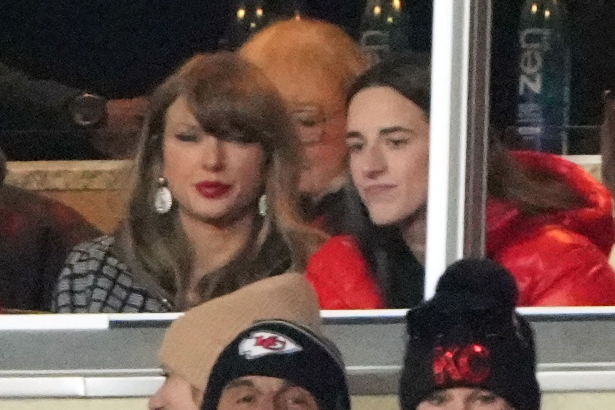 Recording artist Taylor Swift sits with Indiana Fever guard Caitlin Clark.