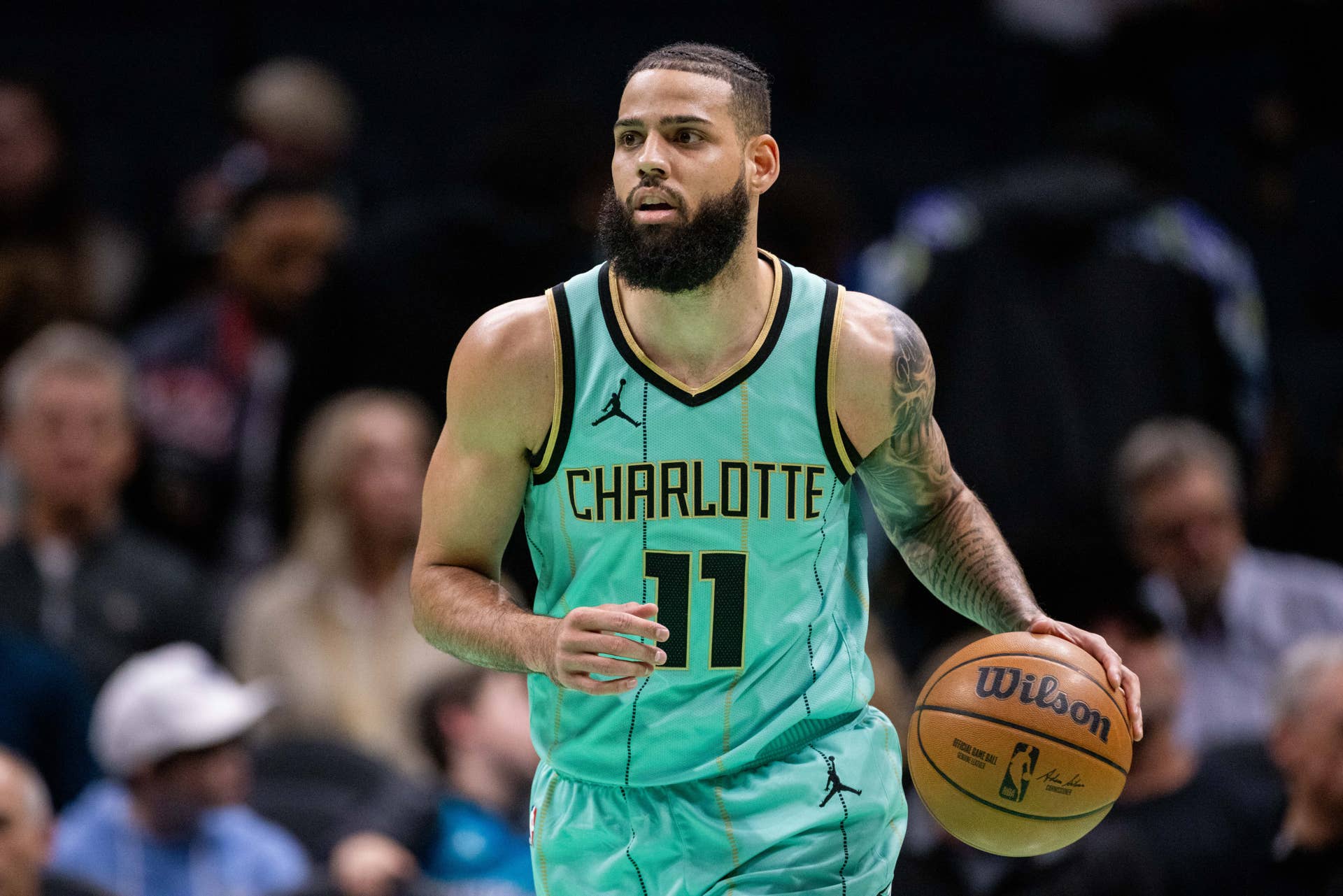 an 24, 2025; Charlotte, North Carolina, USA; Charlotte Hornets forward Cody Martin (11) brings the ball up court against the Portland Trail Blazers during the first quarter at Spectrum Center. Mandatory Credit: Scott Kinser-Imagn Images