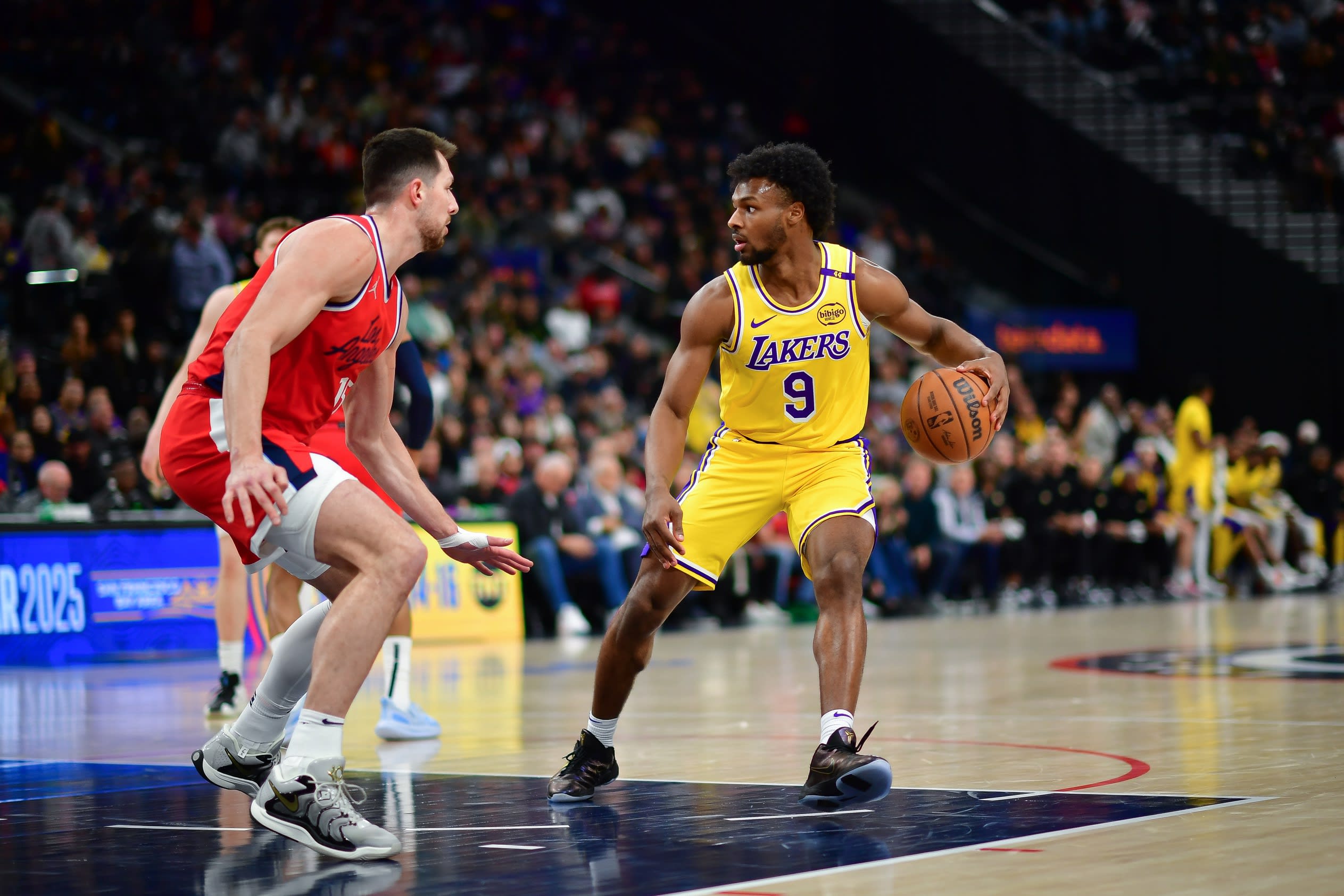 Feb 4, 2025; Inglewood, California, USA; Los Angeles Lakers guard Bronny James (9) controls the ball against Los Angeles Clippers forward Drew Eubanks (15) during the second half at Intuit Dome. Mandatory Credit: Gary A. Vasquez-Imagn Images