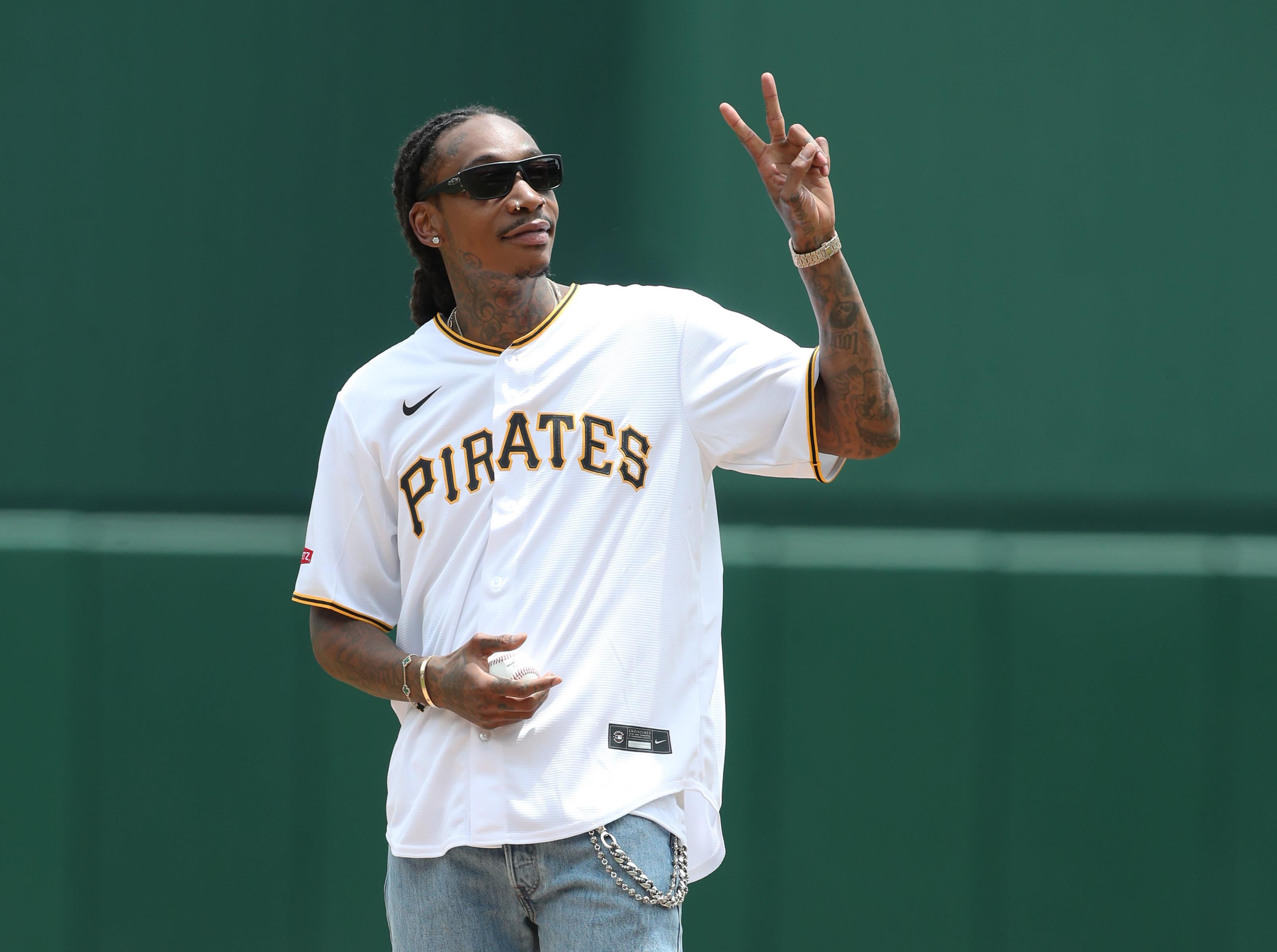 Wiz Khalifa gestures before throwing out a ceremonial first pitch prior to the Pittsburgh Pirates hosting the Chicago White Sox at PNC Park.