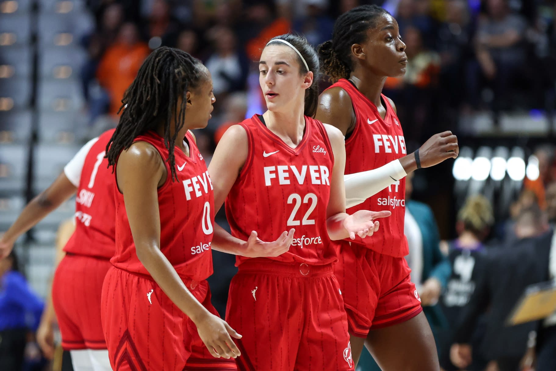 Sep 25, 2024; Uncasville, Connecticut, USA; Indiana Fever guard Caitlin Clark (22) talks to Indiana Fever guard Kelsey Mitchell (0) during the first half during game two of the first round of the 2024 WNBA Playoffs at Mohegan Sun Arena.

