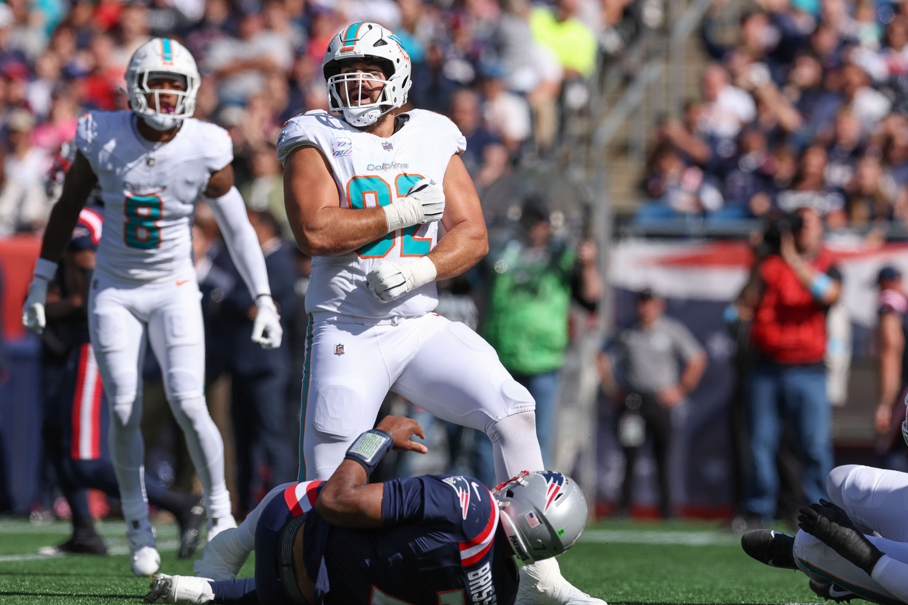 Miami Dolphins defensive tackle Zach Sieler (92) celebrates after a sack of New England Patriots quarterback Jacoby Brissett (7) during the first half at Gillette Stadium.