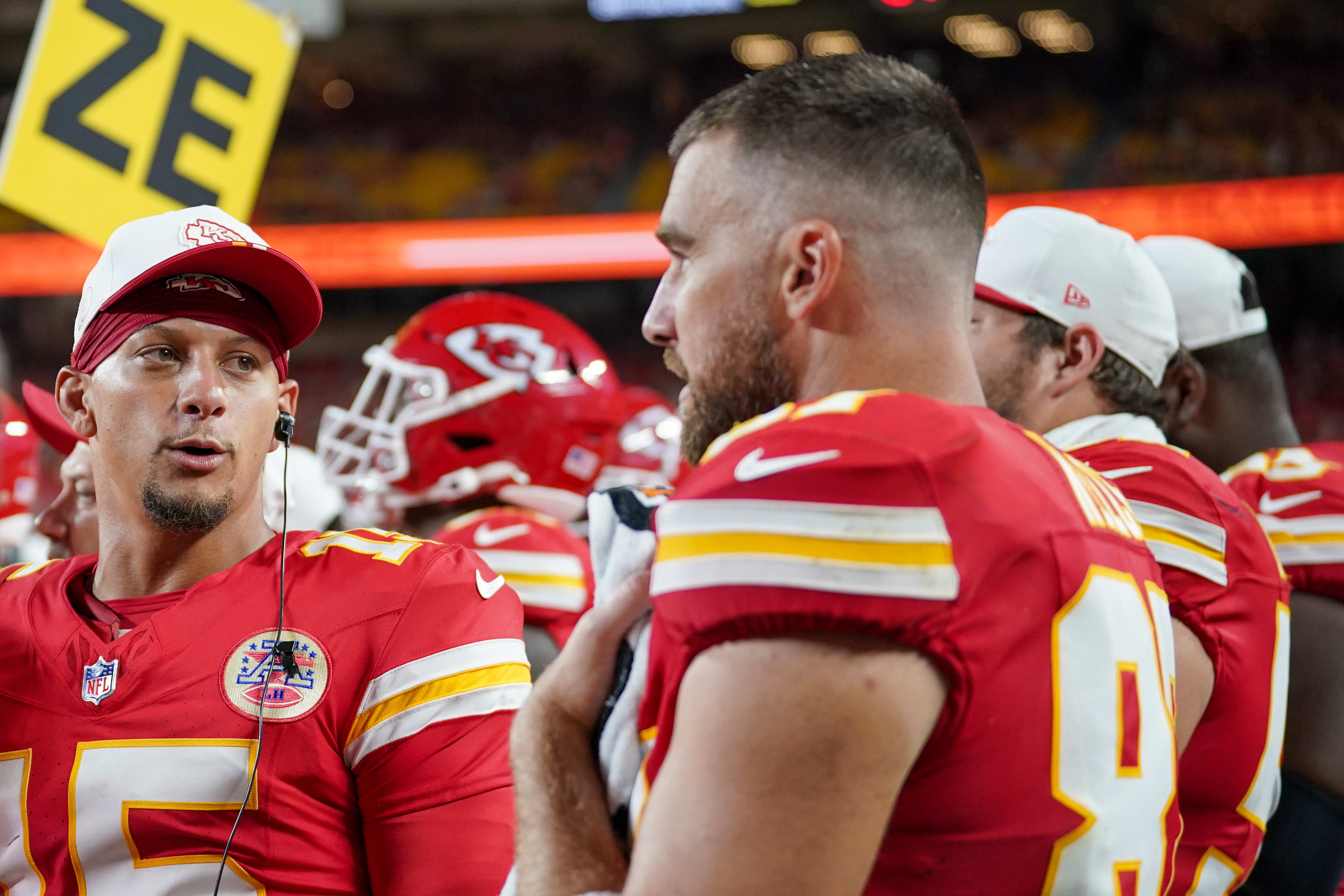 Kansas City Chiefs quarterback Patrick Mahomes (15) talks with tight end Travis Kelce (87) on the sidelines.