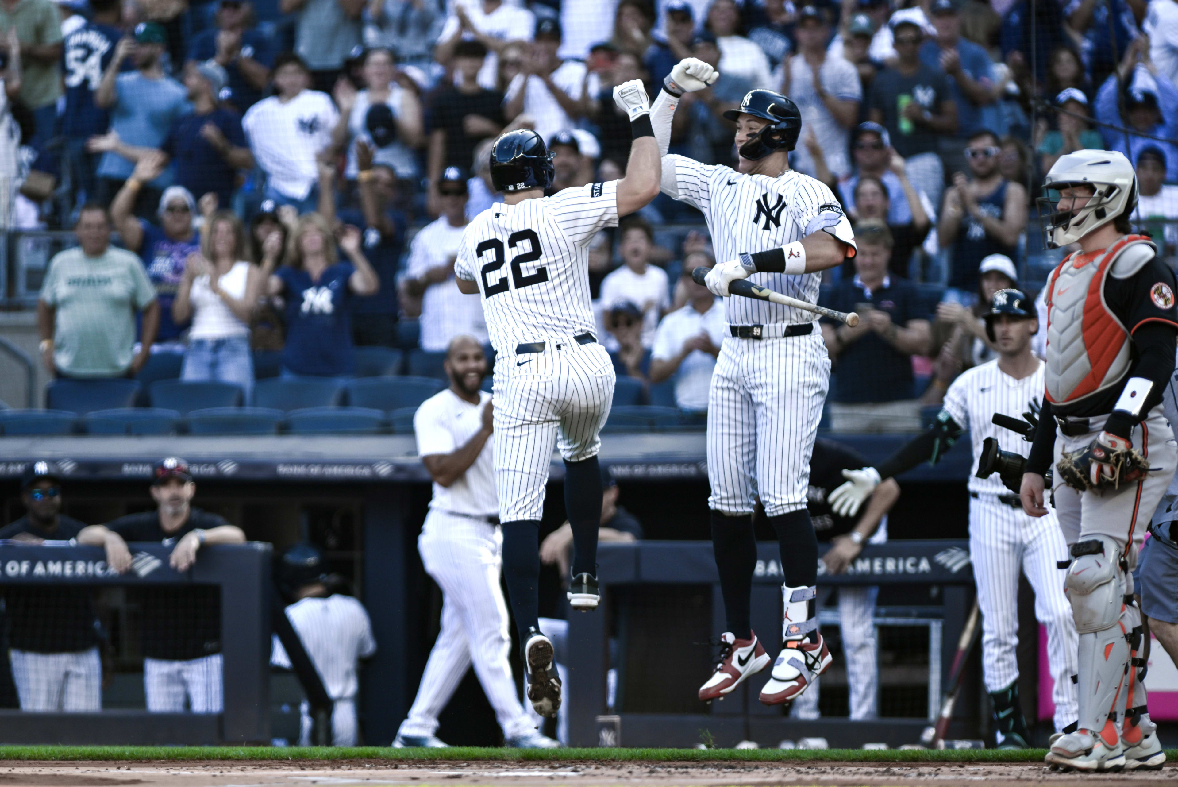 New York Yankees first baseman Ben Rice (22) celebrates at home plate with outfielder Aaron Judge (99) after hitting a solo home run against the Baltimore Orioles during the first inning at Yankee Stadium.