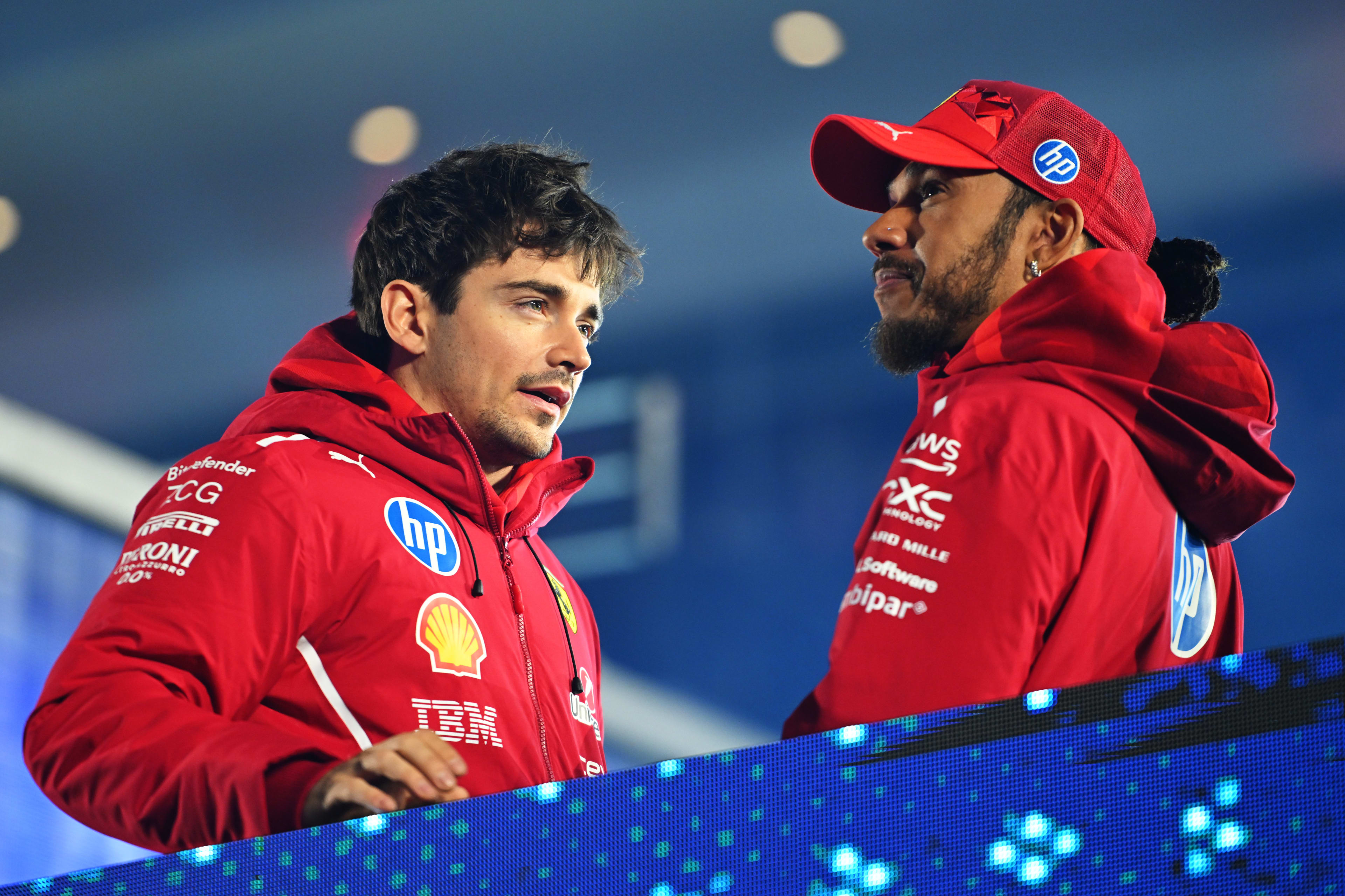 Charles Leclerc of Monaco and Scuderia Ferrari and Lewis Hamilton of Great Britain and Scuderia Ferrari talk on the drivers parade prior to the F1 Grand Prix of Las Vegas at Las Vegas Strip Circuit on November 22, 2025 in Las Vegas, Nevada.