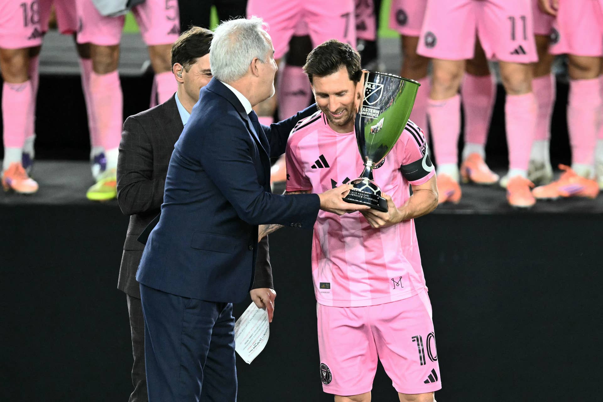Inter Miami's Argentine forward #10 Lionel Messi accepts the trophy from Inter Miami's managing owner Jorge Mas (L) after his team's victory in the Major League Soccer (MLS) Eastern Conference final football match between Inter Miami and New York City FC at Chase Stadium in Fort Lauderdale, Florida on November 29, 2025. Lionel Messi and Inter Miami reached the MLS Cup final for the first time on November 29, 2025 after a 5-1 thrashing of New York City FC in the Eastern Conference playoffs.