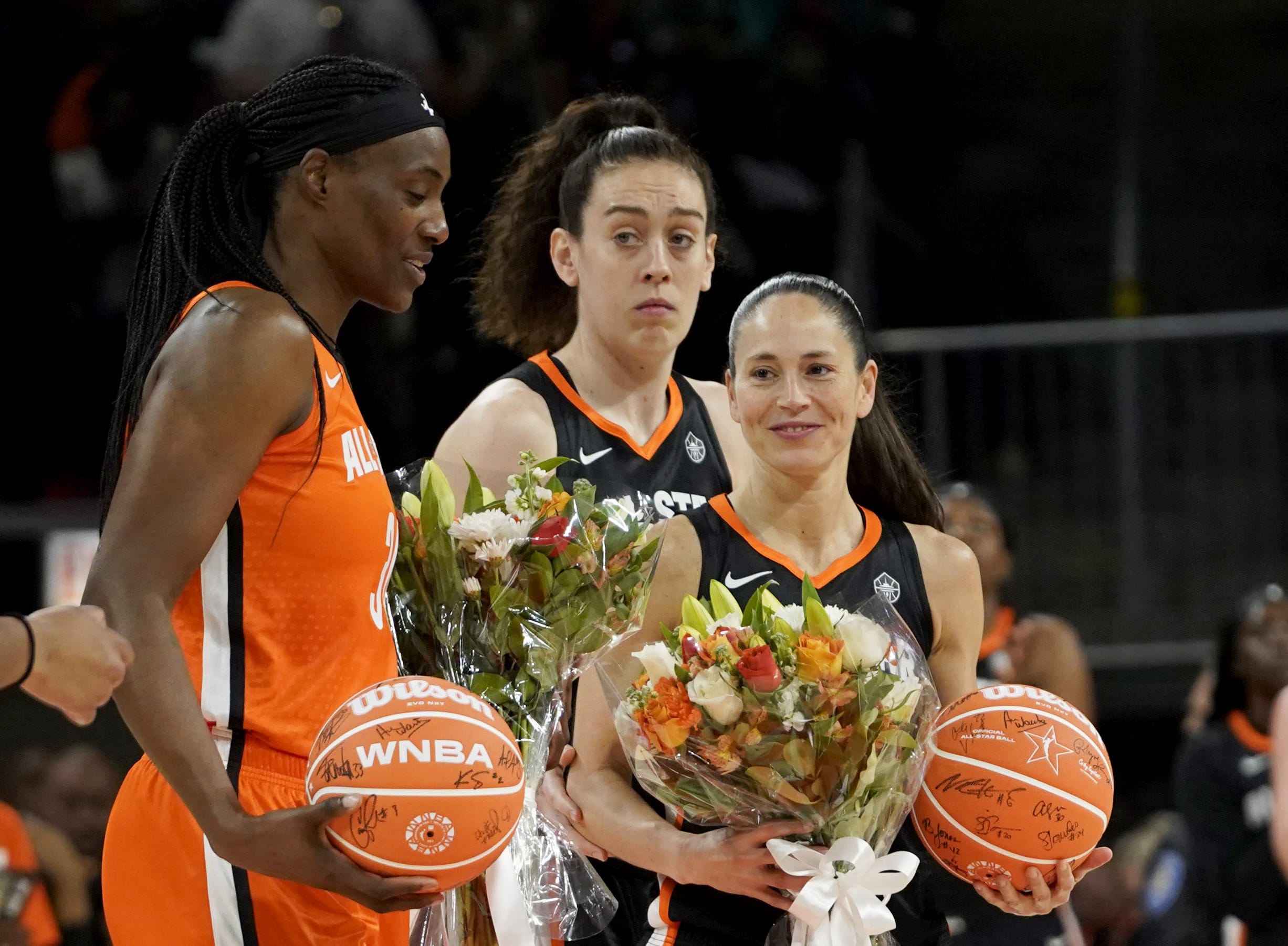 Team Stewart guard Sue Bird (right) and Team Wilson center Sylvia Fowles (left) are presented with flowers.
