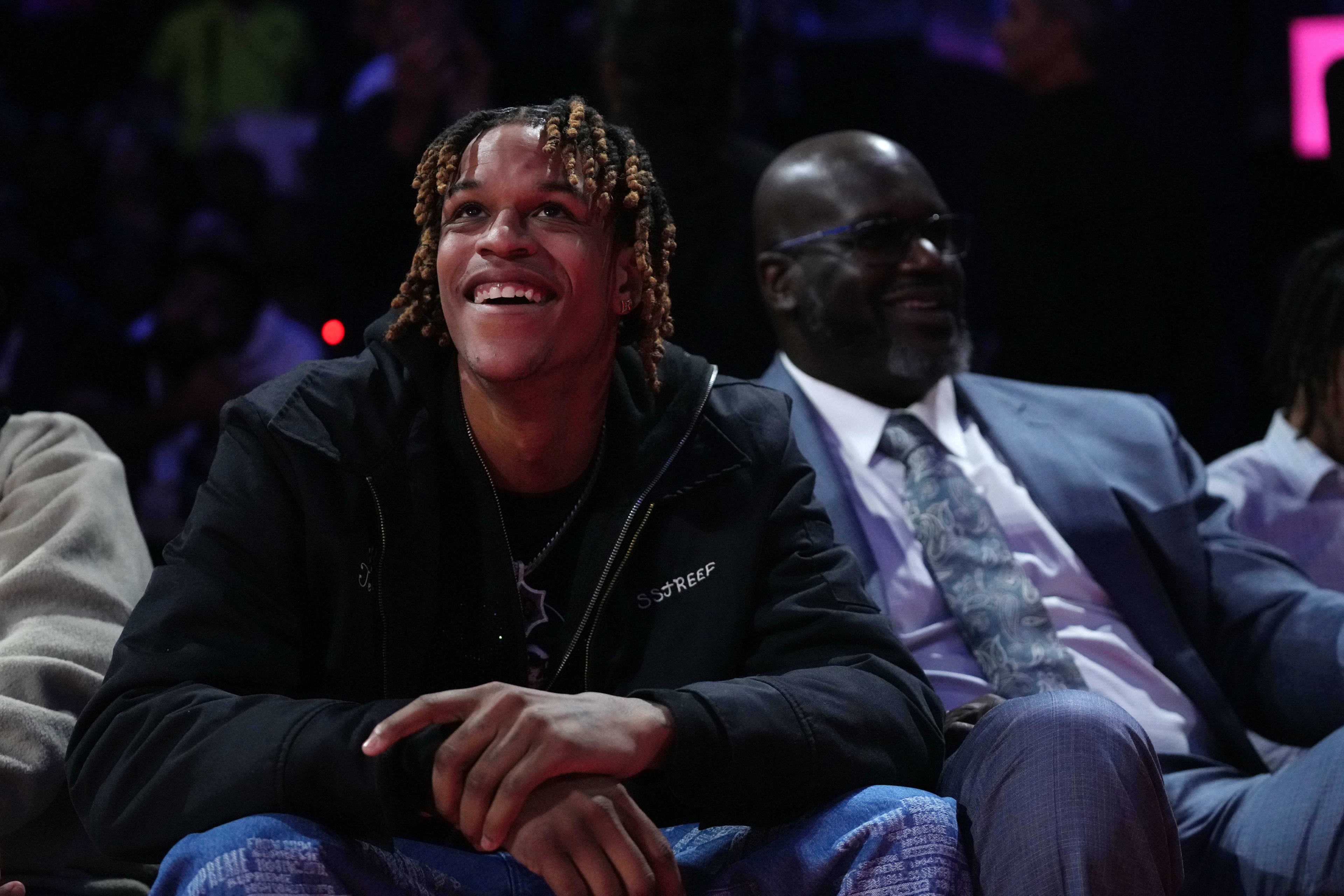 Shaquille O'Neal and son Shareef watch a Los Angeles Lakers game from the court side