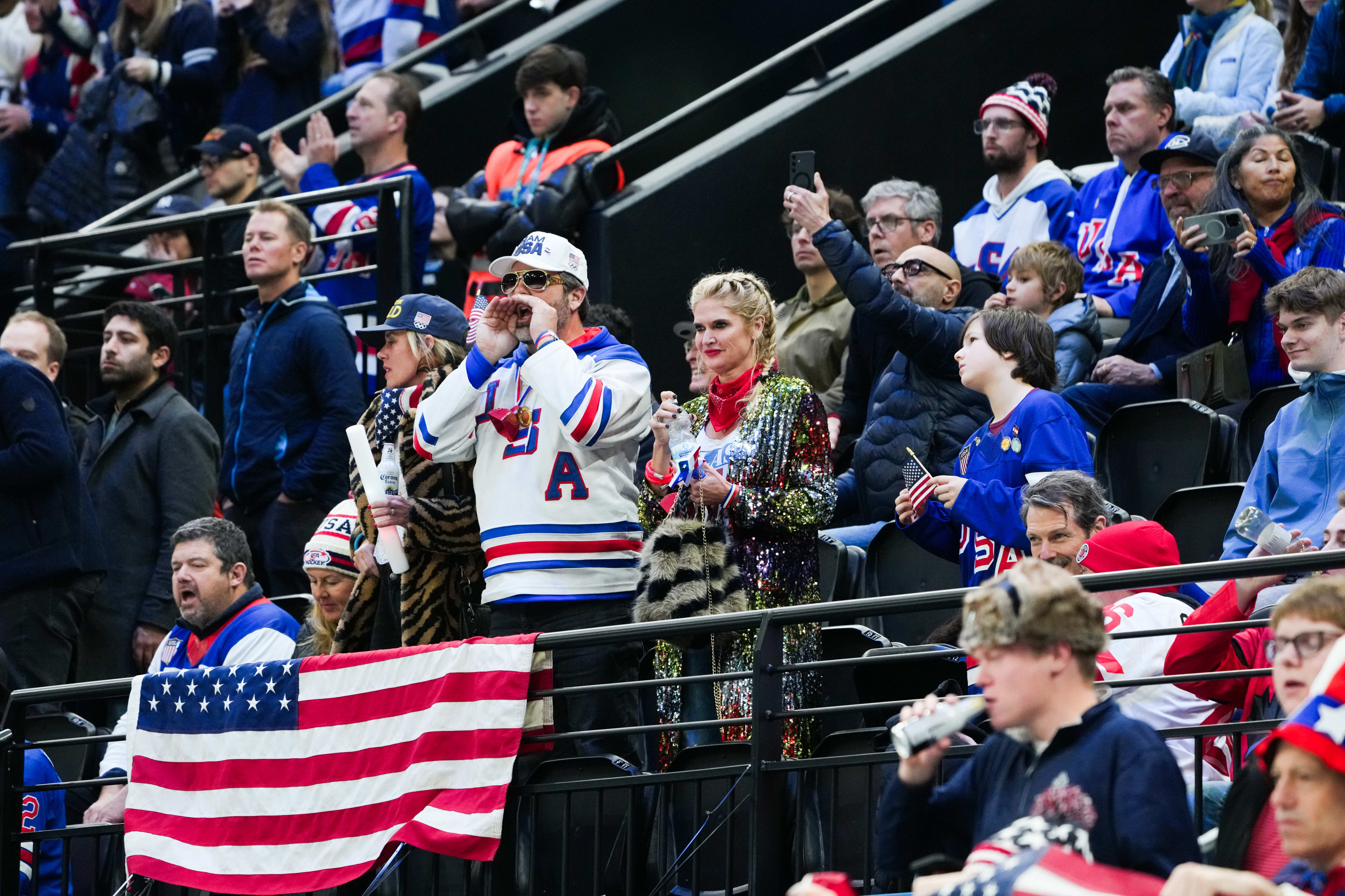 Team USA fans cheer their team during hockey finals in the Winter Olympics
